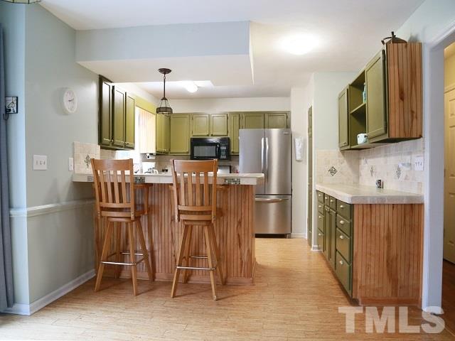 2300 Rolesville Road Wake Forest, NC 27587 - Photo 9 of 24 a kitchen with stainless steel appliances kitchen island granite countertop a refrigerator and microwave