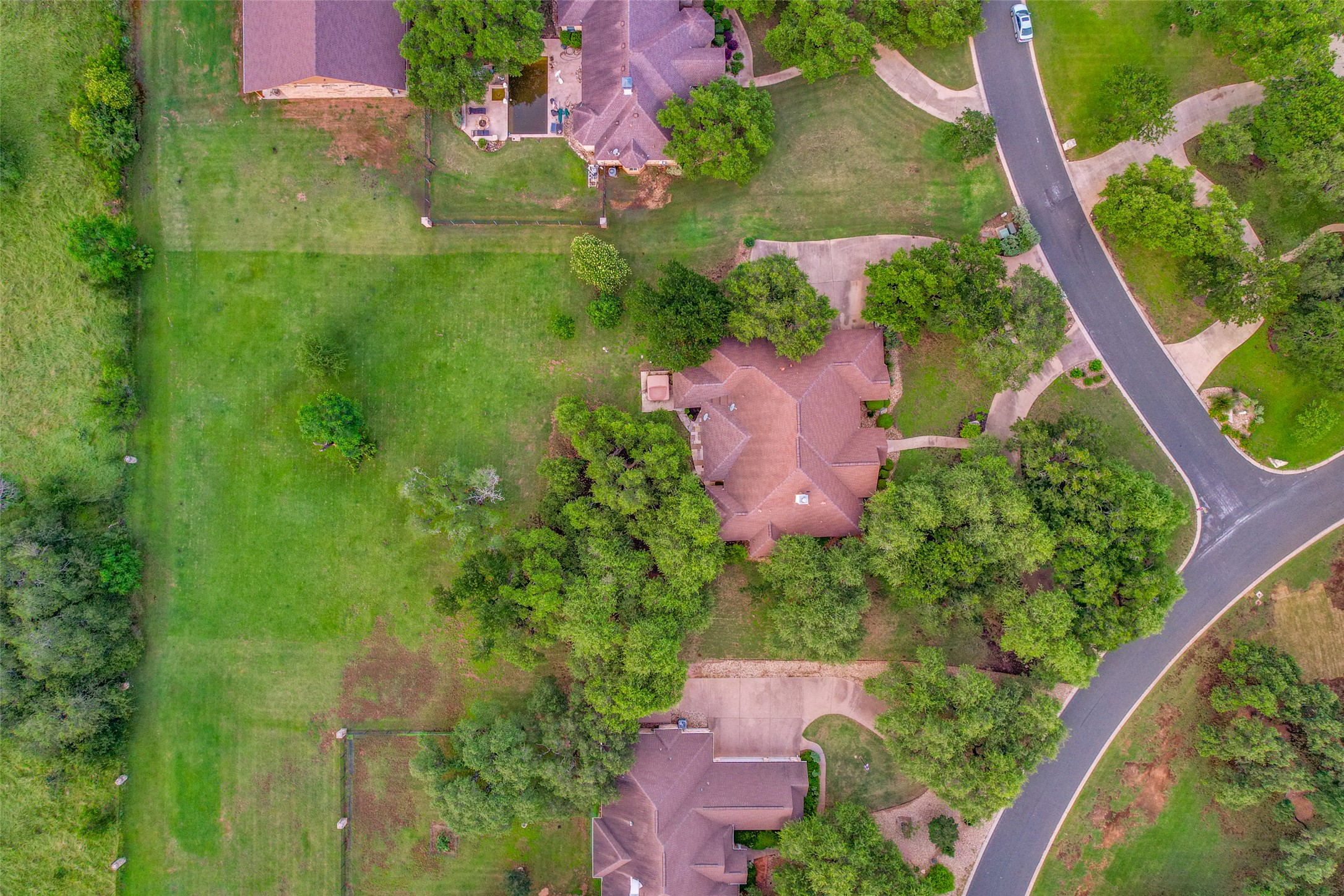 101 Copper Leaf Court Georgetown, TX 78633 - Photo 28 of 31 Aerial view showcasing a residential property with a multi-gabled roof and surrounding mature trees