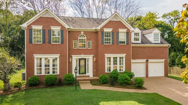 front view of a house next to a yard