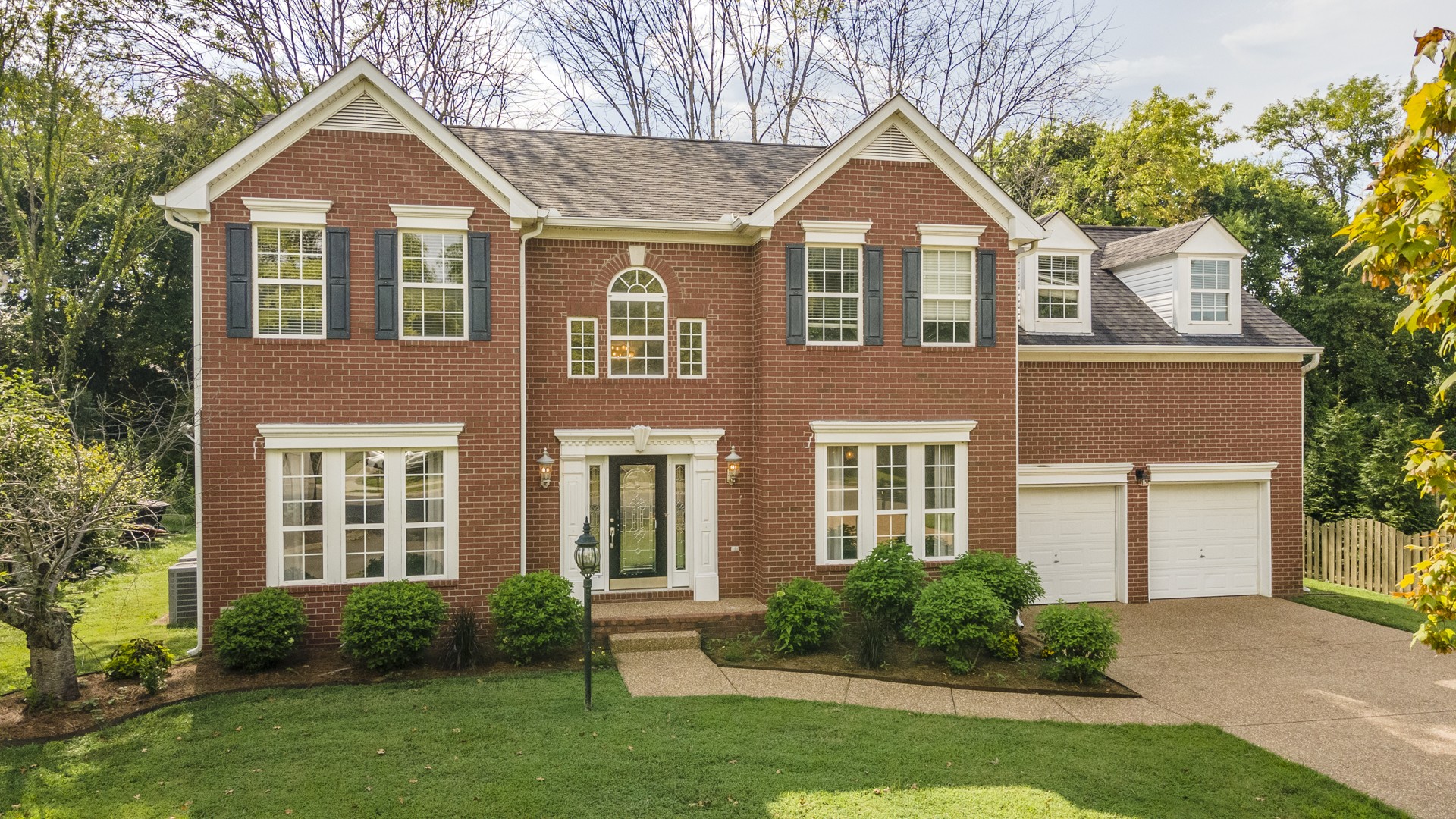front view of a house next to a yard