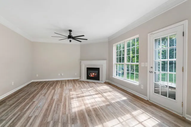 a view of a livingroom with a ceiling fan and window