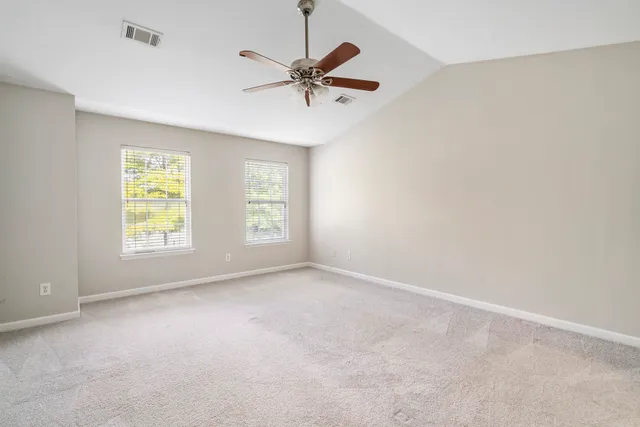 a view of a livingroom with a ceiling fan and window