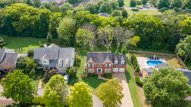 an aerial view of a house with pool garden and outdoor seating