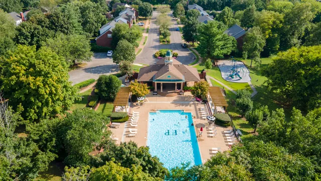 an aerial view of a house with a yard and trees