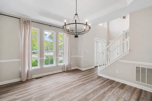 a view of an entryway with wooden floor and door