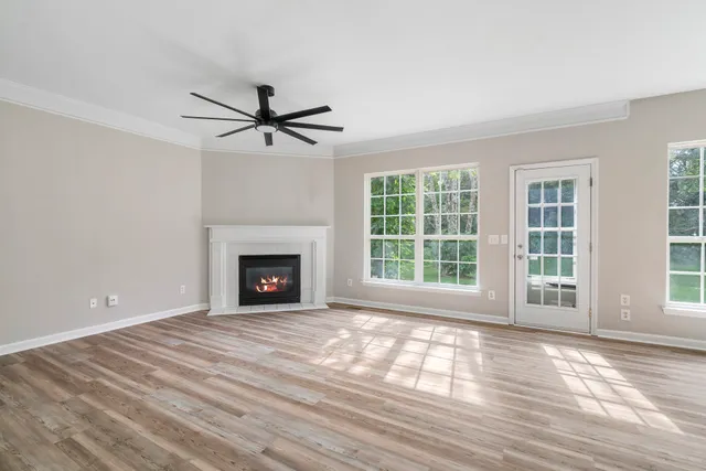 a view of a livingroom with a fireplace and window