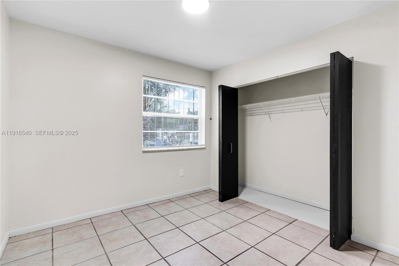 1253 Northwest 44th Street Miami, FL 33142 - Photo 14 of 25 a view of an empty room and window