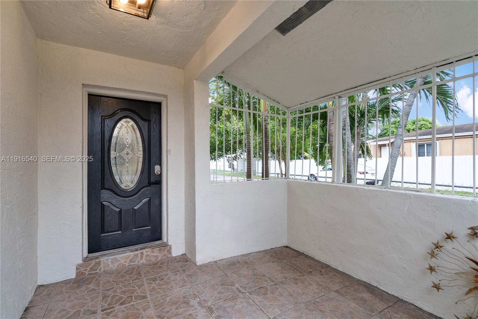 1253 Northwest 44th Street Miami, FL 33142 - Photo 19 of 25 wooden floor in an empty room with a window