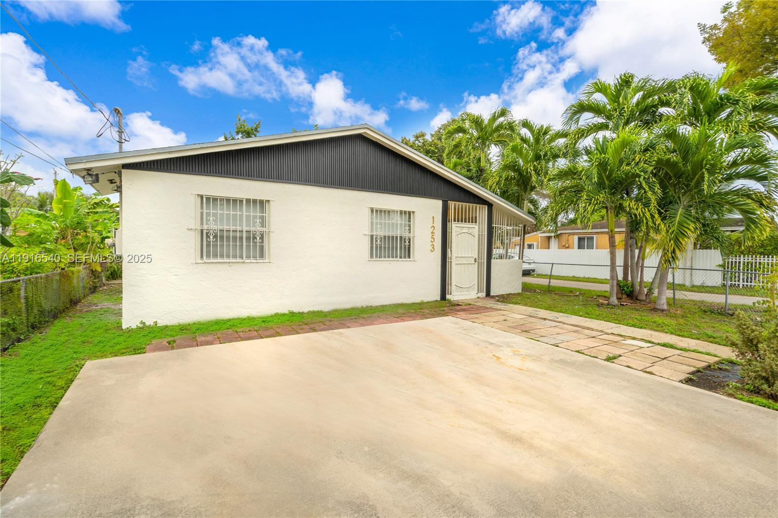 1253 Northwest 44th Street Miami, FL 33142 - Photo 20 of 25 a view of backyard of house with green space