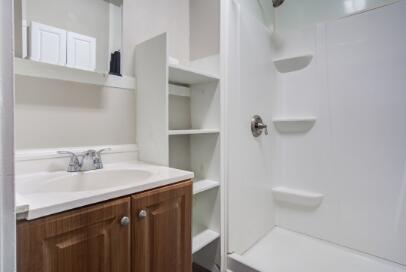 2305 14th Street, Unit B Lubbock, TX 79401 - Photo 13 of 14 a bathroom with a sink a toilet and a mirror