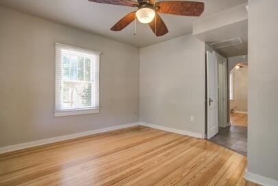 2305 14th Street, Unit B Lubbock, TX 79401 - Photo 4 of 14 a view of empty room with wooden floor and fan