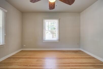 2305 14th Street, Unit B Lubbock, TX 79401 - Photo 5 of 14 a room with window and wooden floor