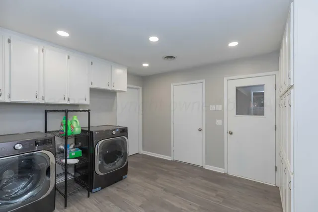 a room with a washing machine and utility room