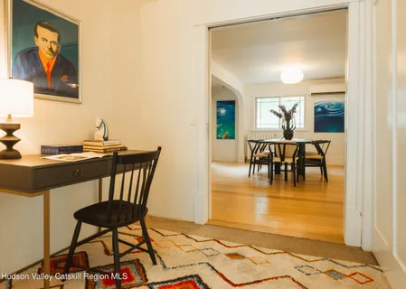 a view of a dining room with furniture and a potted plant