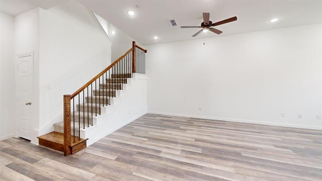 285 Buck Ridge Drive Little Elm, TX 75068 - Photo 7 of 20 a view of a hallway with wooden floor and a ceiling fan