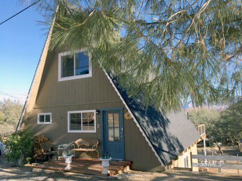 74 Adams Road Wofford Heights, CA 93285 - Photo 1 of 15 a front view of a house with trees