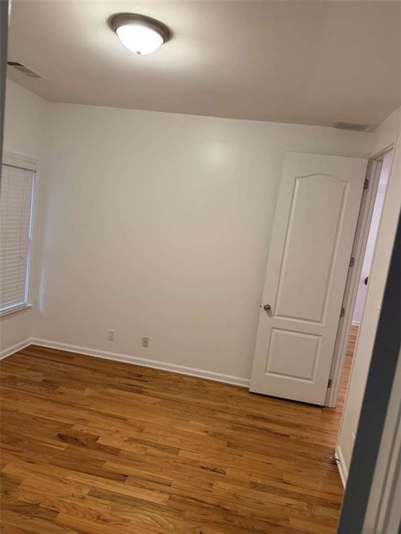 105 Beracah Walk Atlanta, GA 30331 - Photo 14 of 17 a view of an empty room with wooden floor