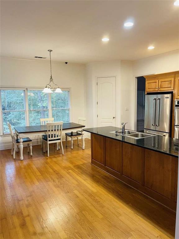 105 Beracah Walk Atlanta, GA 30331 - Photo 4 of 17 a room with stainless steel appliances kitchen island granite countertop a table chairs and a large window