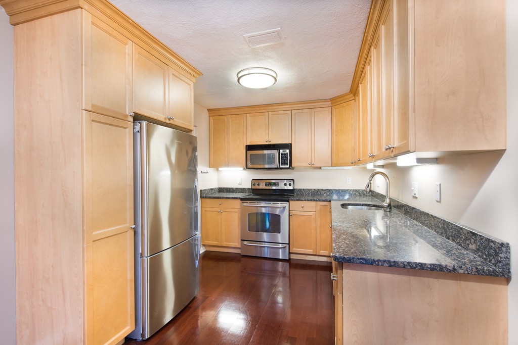 a kitchen with a refrigerator a sink and a stove
