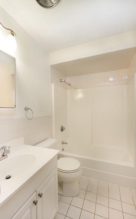 360 Neponset Street, Unit 702 Canton, MA 02021 - Photo 5 of 6 a bathroom with a sink a toilet and shower