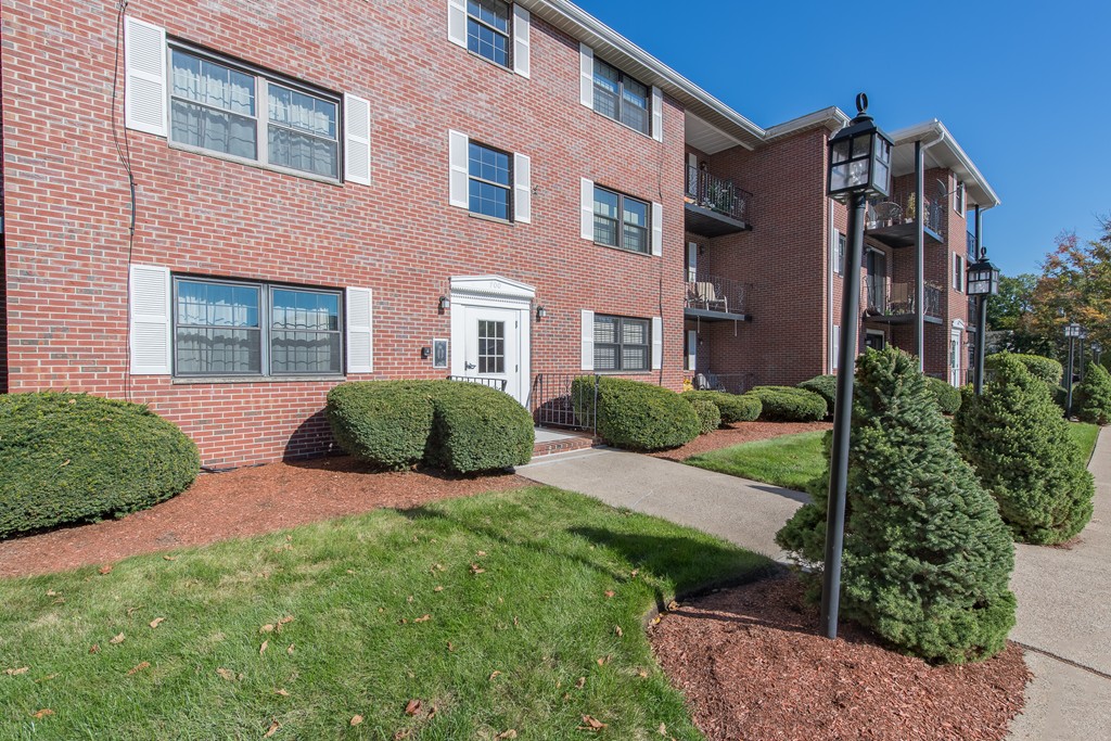 360 Neponset Street, Unit 702 Canton, MA 02021 - Photo 6 of 6 a view of a building with a yard