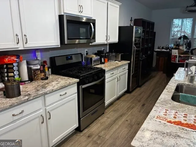 a kitchen with a sink stove and refrigerator