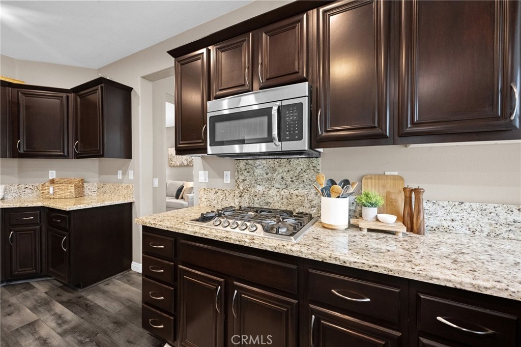7220 Cumberland Place Rancho Cucamonga, CA 91739 - Photo 14 of 41 Detailed view of the kitchen's tile backsplash, stainless appliances, and ample cabinet storage.