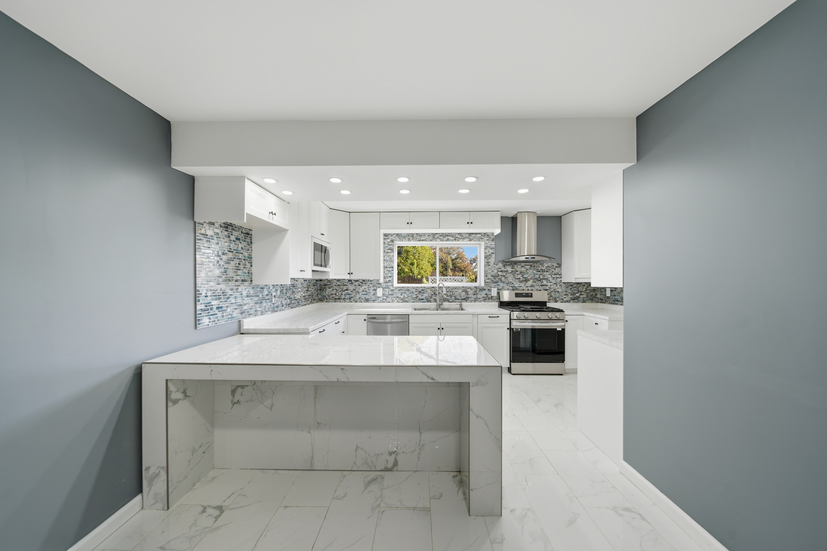 503 West Winfield Street Morrison, IL 61270 - Photo 6 of 22 a large white kitchen with a sink and dishwasher a stove top oven with wooden floor