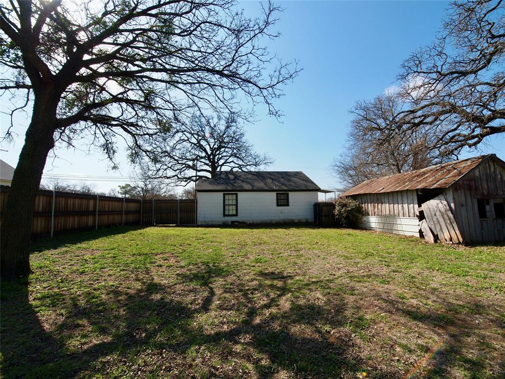 1327 Old Jacksboro Road Graham, TX 76450 - Photo 23 of 33 a house with a tree in front of it