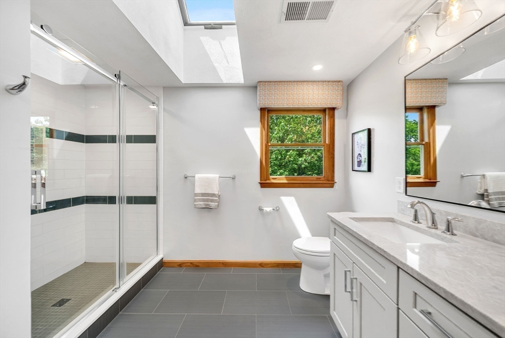 83 Jefferson Road Franklin, MA 02038 - Photo 16 of 34 a bathroom with a granite countertop sink a toilet a mirror and shower