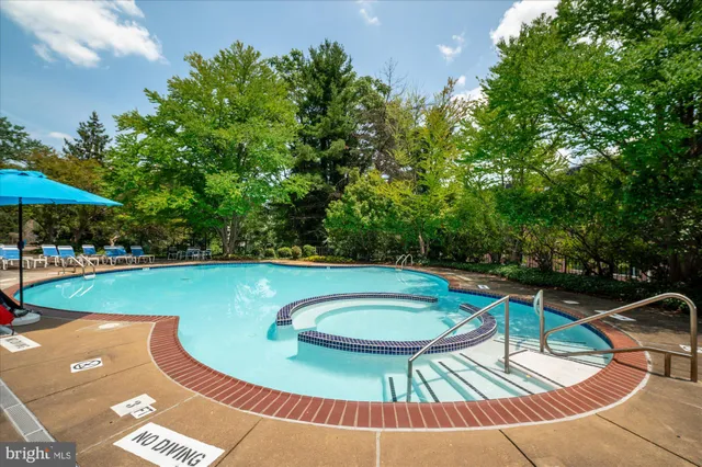 a view of a swimming pool with an outdoor space and seating area
