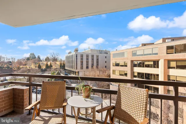 a balcony with table and chairs