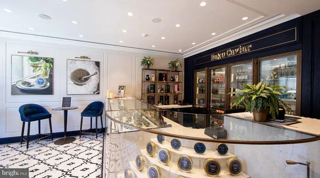 a living room with furniture a rug and white walls