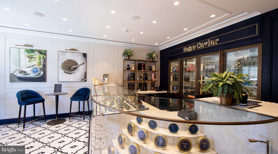 2111 Wisconsin Avenue Northwest, Unit 606 Washington, DC 20007 - Photo 21 of 22 a living room with furniture a rug and white walls