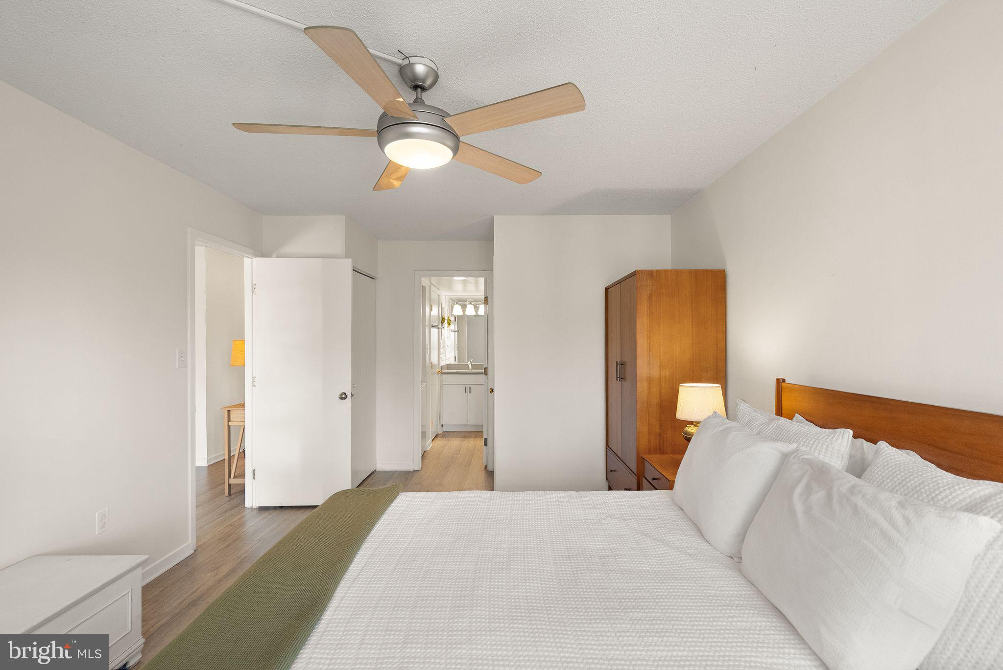 2111 Wisconsin Avenue Northwest, Unit 606 Washington, DC 20007 - Photo 7 of 22 a bedroom with a bed and a chandelier