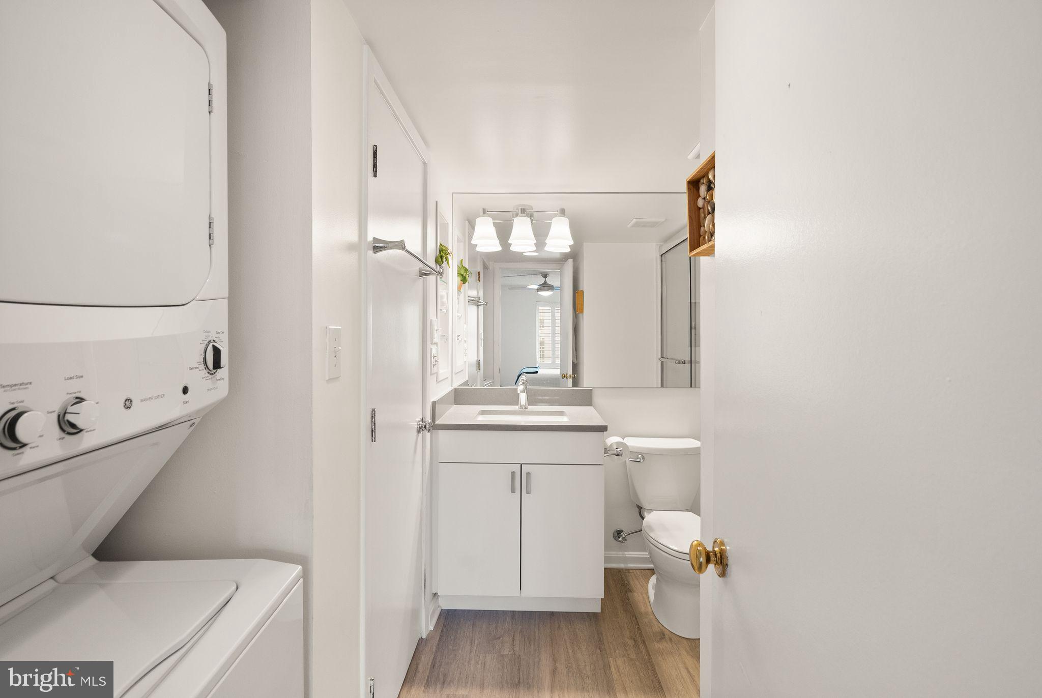 2111 Wisconsin Avenue Northwest, Unit 606 Washington, DC 20007 - Photo 8 of 22 a bathroom with a toilet a sink and mirror