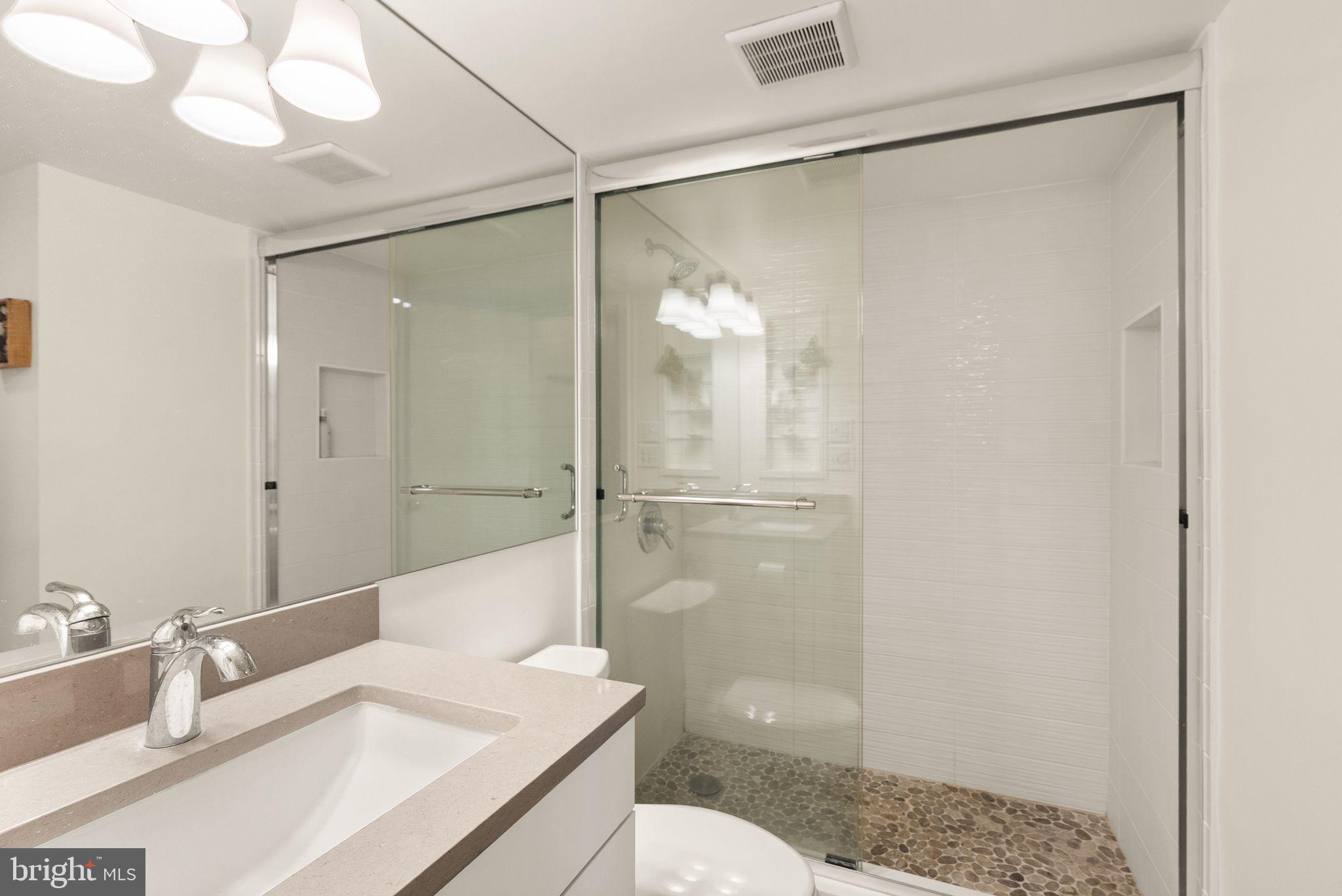 2111 Wisconsin Avenue Northwest, Unit 606 Washington, DC 20007 - Photo 9 of 22 a bathroom with a sink a toilet and shower