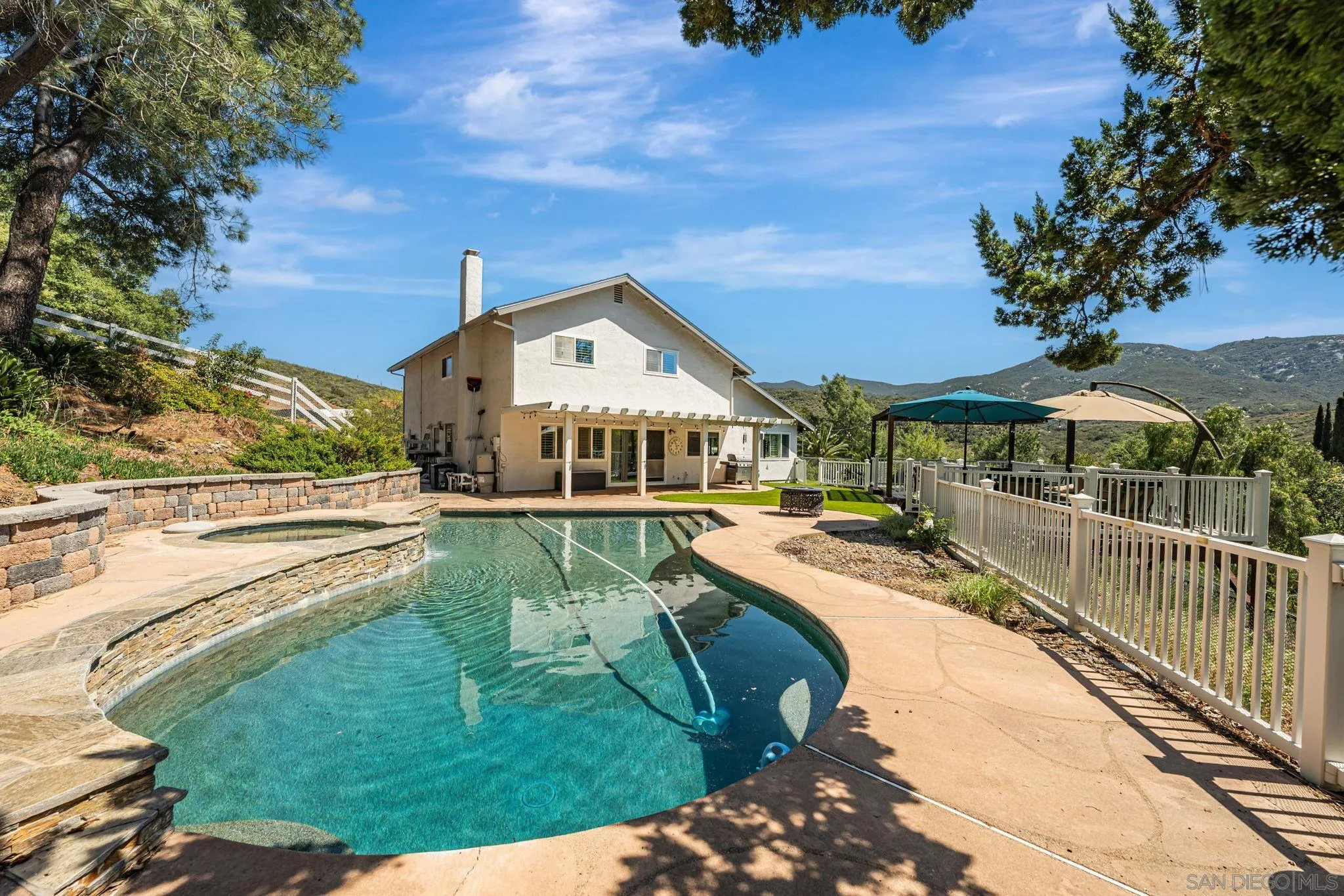 a view of a house with pool yard and outdoor seating