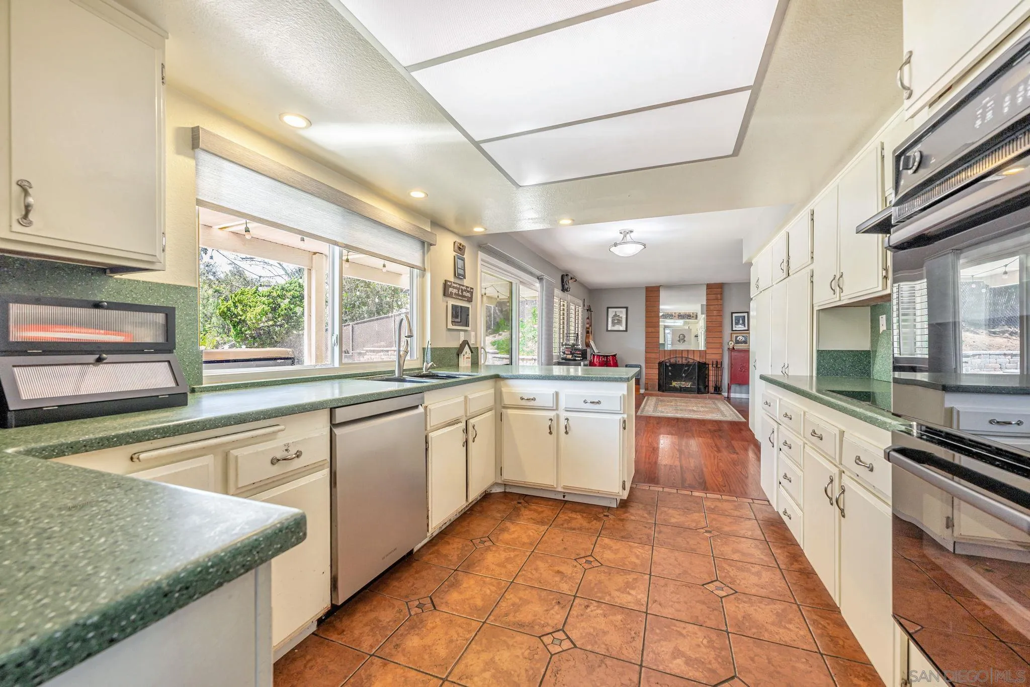 3304 Del Charro Road Jamul, CA 91935 - Photo 12 of 44 a large kitchen with stainless steel appliances granite countertop a sink and cabinets