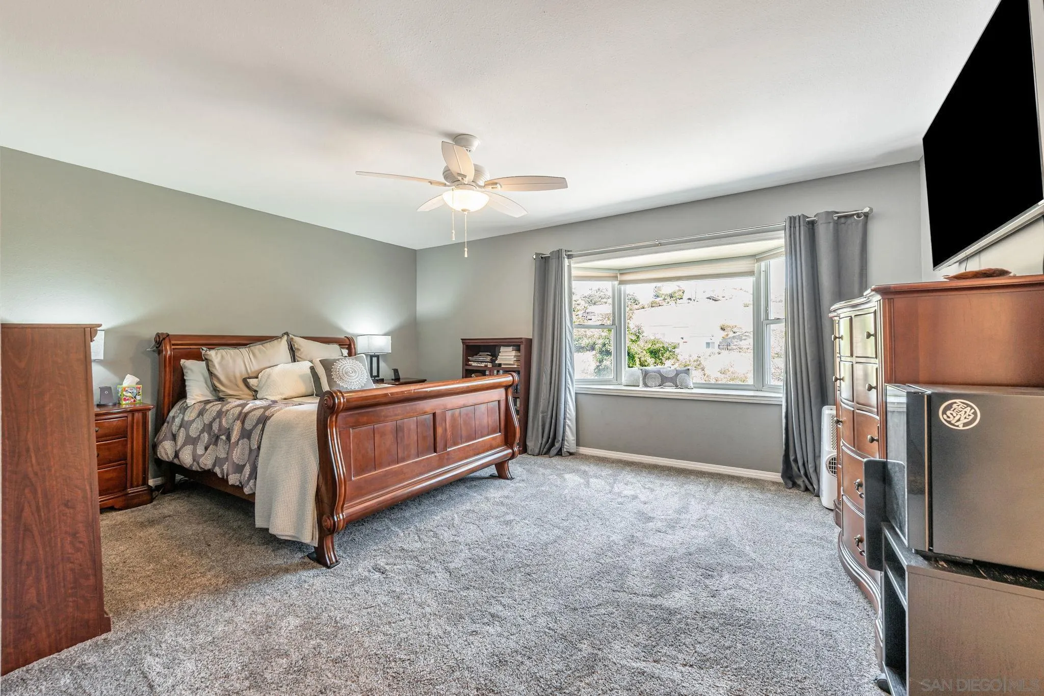 3304 Del Charro Road Jamul, CA 91935 - Photo 24 of 44 a bedroom with a bed and a flat screen tv