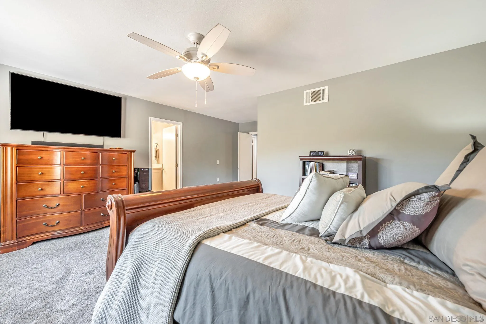 3304 Del Charro Road Jamul, CA 91935 - Photo 26 of 44 a bedroom with a large bed and flat tv screen