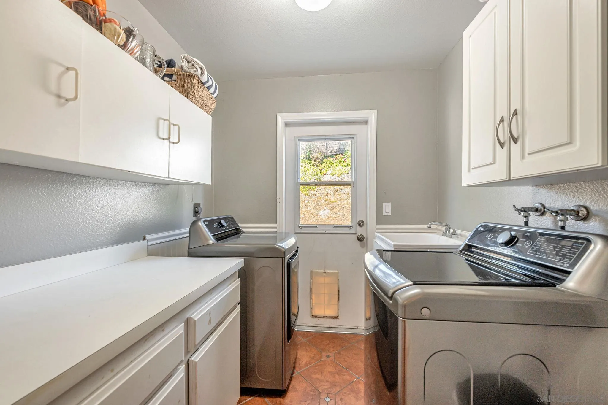 3304 Del Charro Road Jamul, CA 91935 - Photo 32 of 44 a utility room with sink dryer and washer