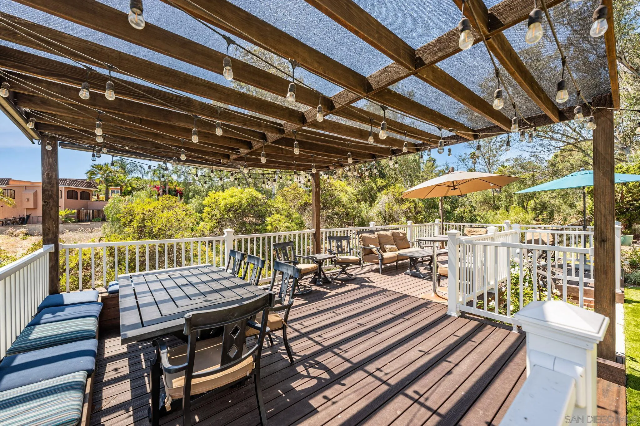 3304 Del Charro Road Jamul, CA 91935 - Photo 35 of 44 a view of a patio with a table chairs and wooden floor
