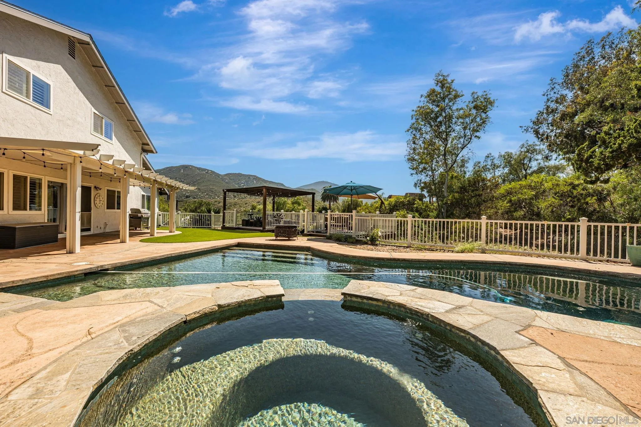 3304 Del Charro Road Jamul, CA 91935 - Photo 39 of 44 a view of a swimming pool with a lounge chairs