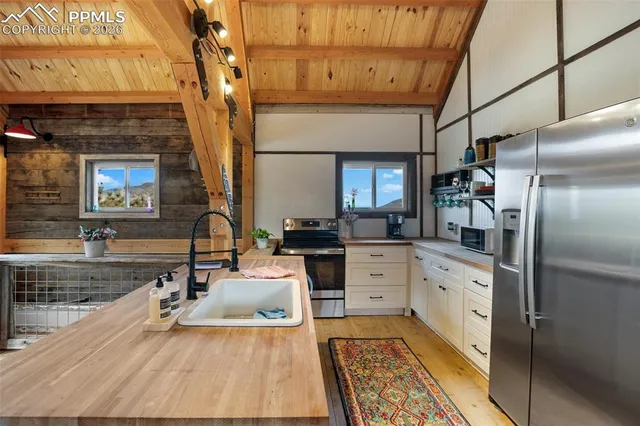 a kitchen with stainless steel appliances granite countertop a refrigerator and a stove