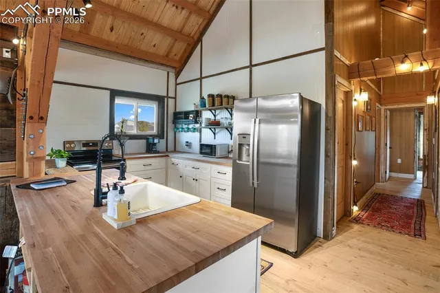 a kitchen with refrigerator and stove