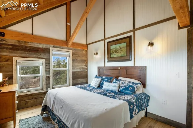 a bedroom with a bed and a large window