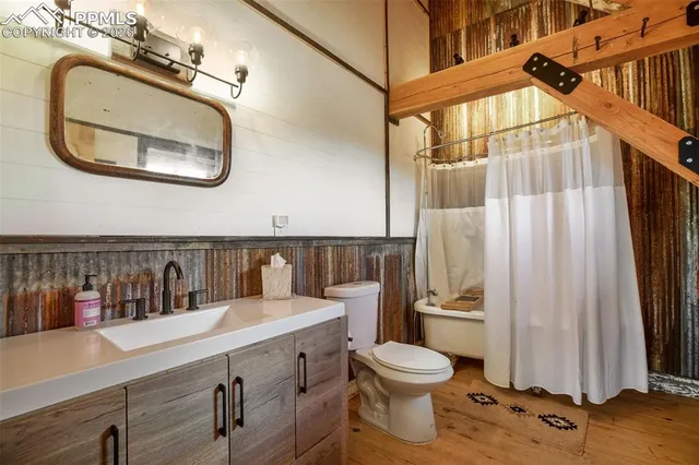 a bathroom with a toilet a sink and a mirror