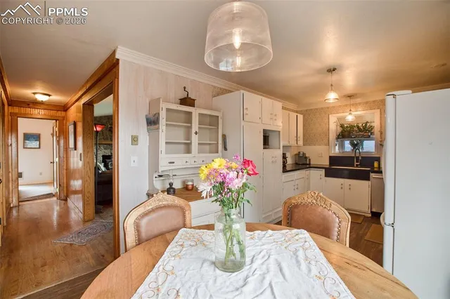 a kitchen with a refrigerator and a chandelier