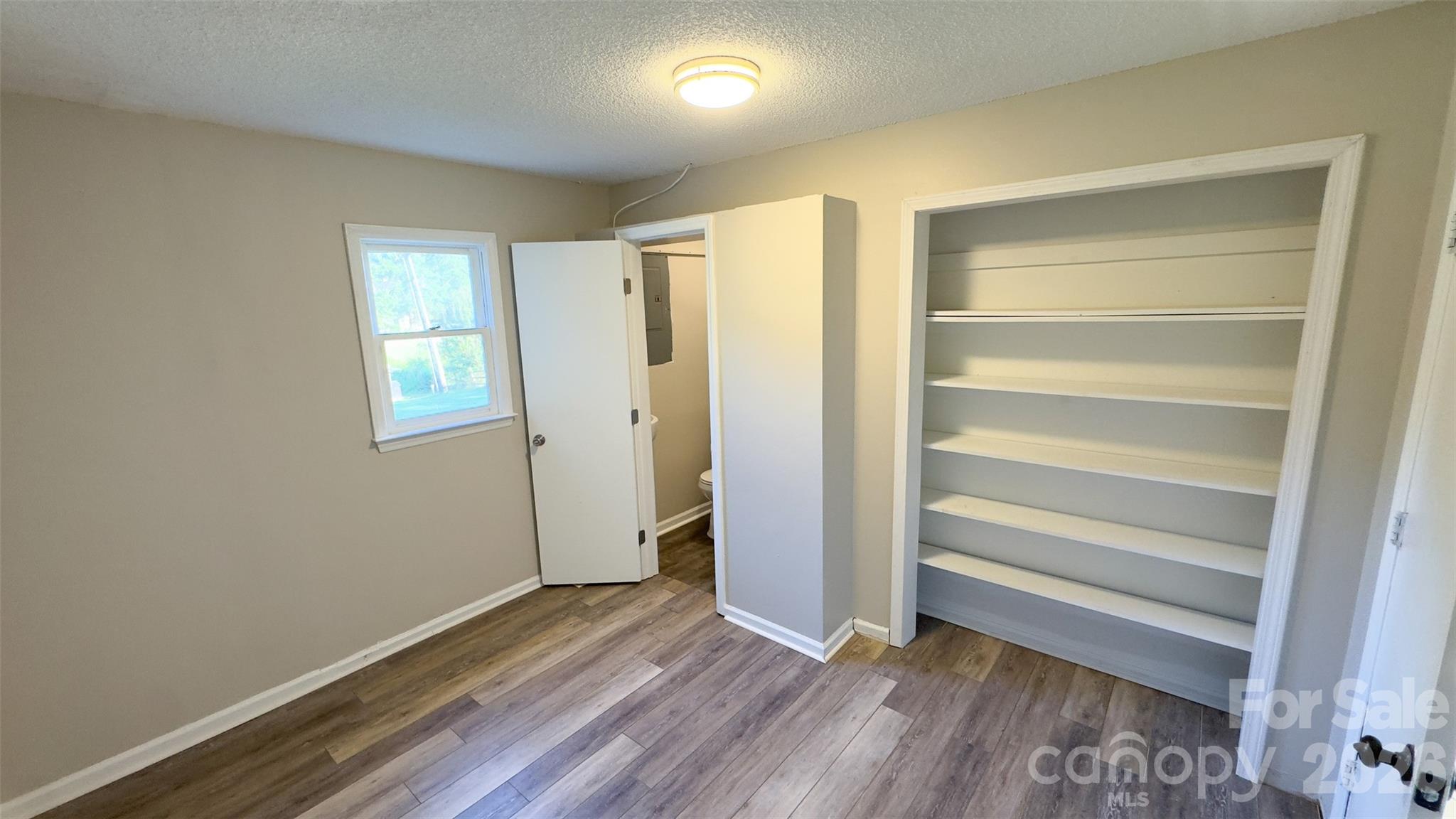3014 Morgan Mill Road Monroe, NC 28110 - Photo 10 of 26 a view of an empty room with wooden floor and a window